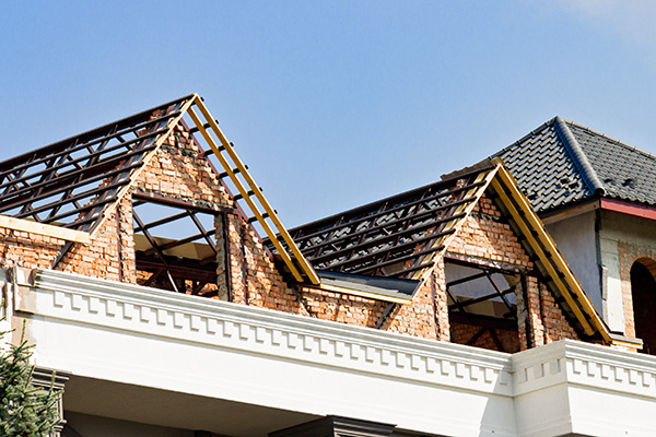 Close up of building a new roof on a brick house