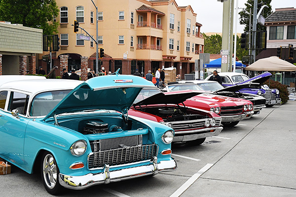 Classic cars with the hoods up dowtown