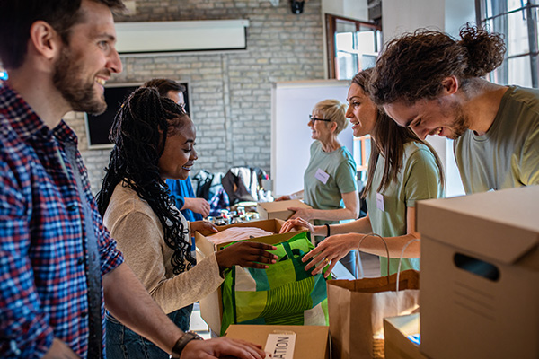 Group of volunteers with working in community charity donation center