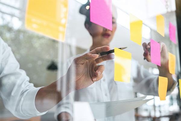 Post it notes on clear board.