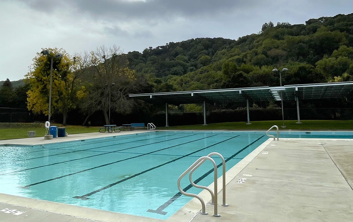 Outdoor swimming pool with solor panel covered greenspace. Swim lanes