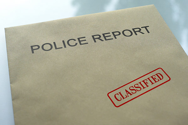 Police report on folder with "classified" seal stamped on.