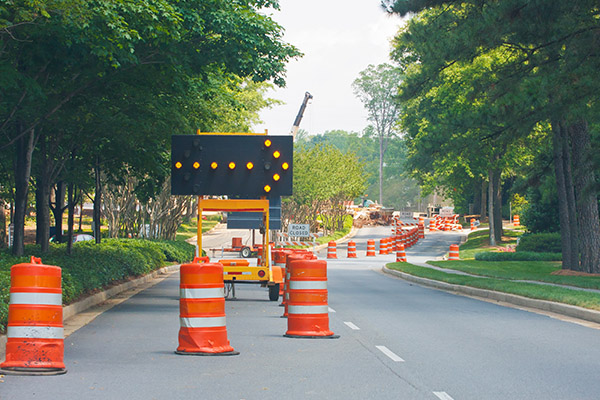 A road construction site with a lane closed sign.