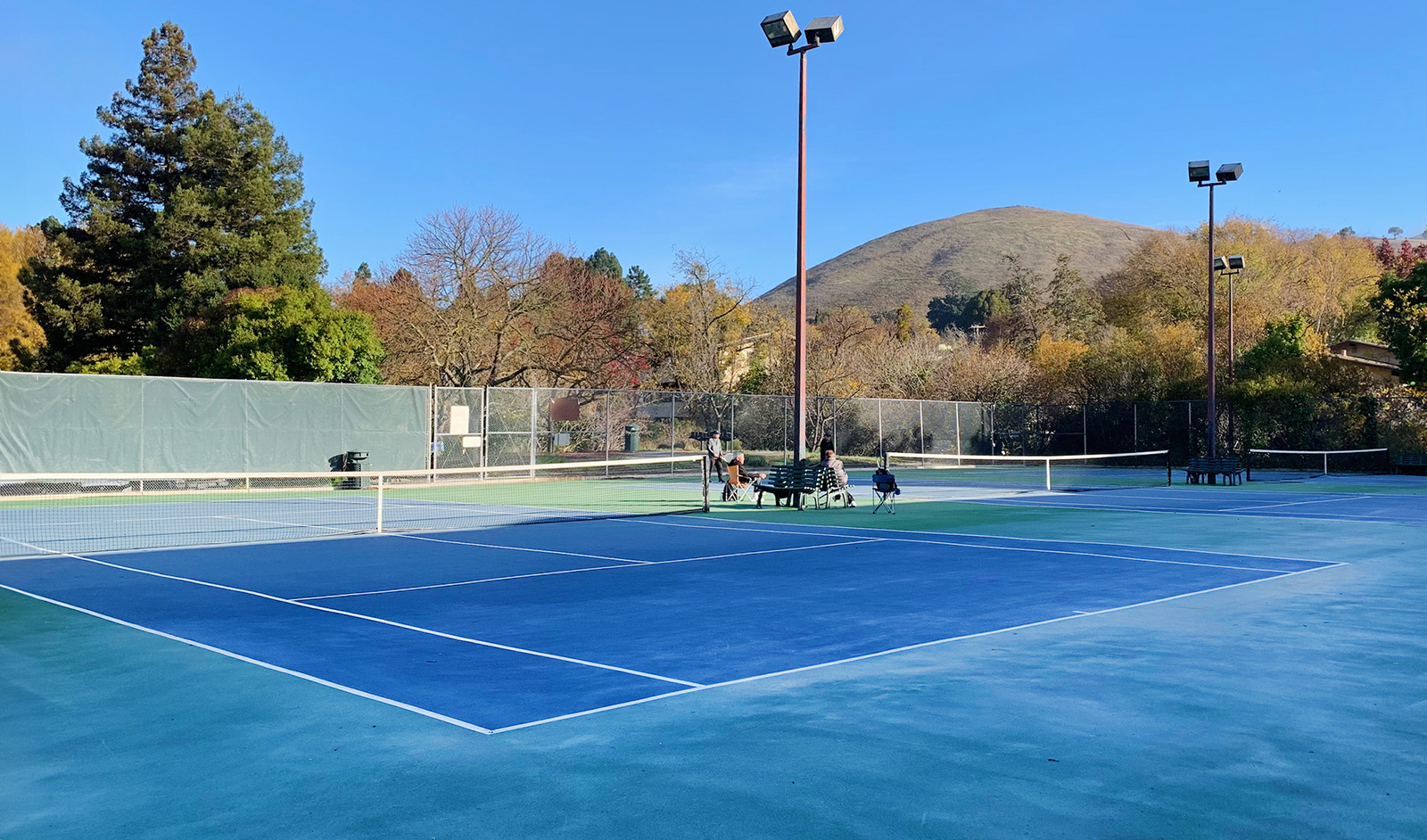 A tennis court in half shade