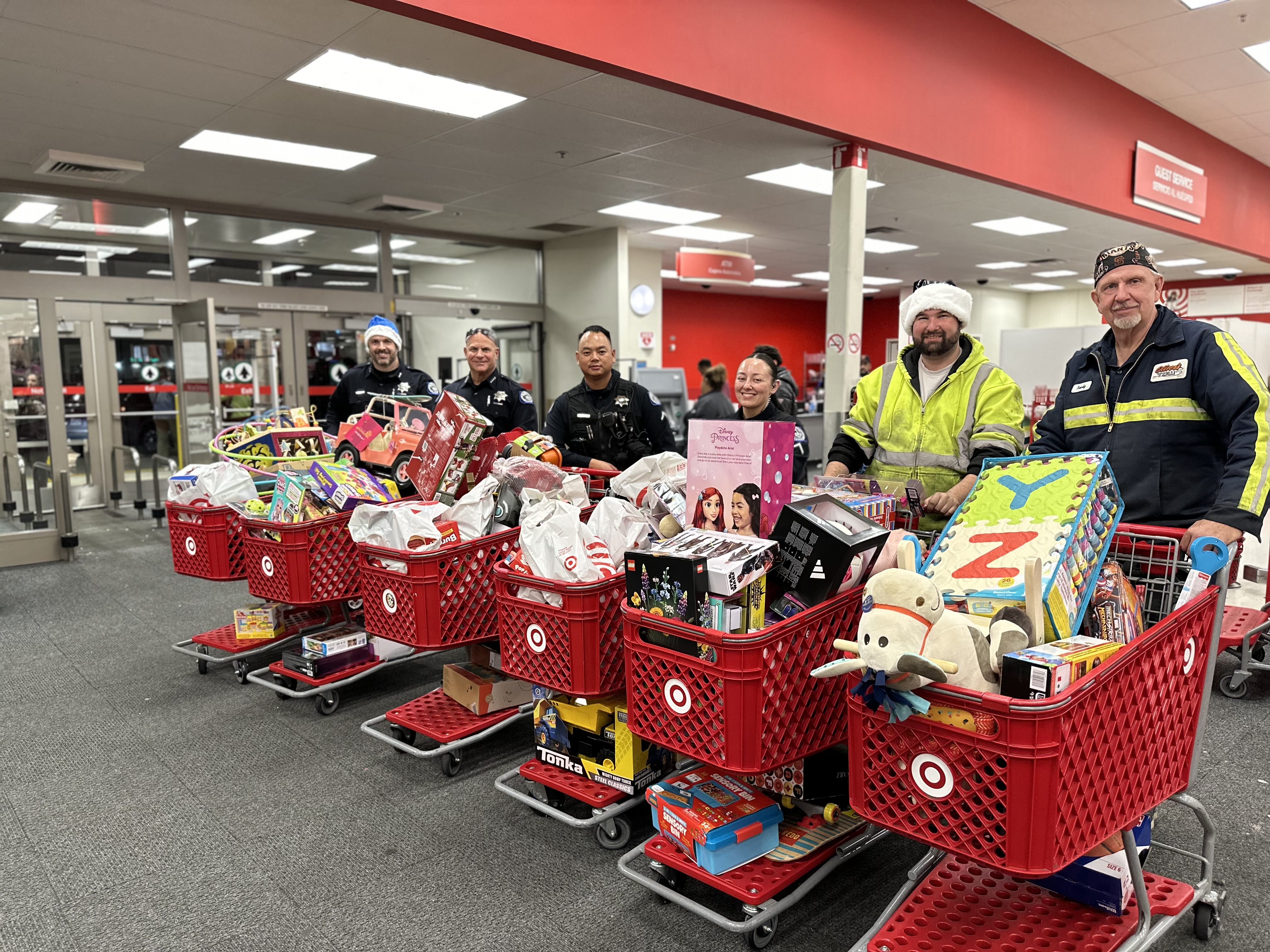 Image of public protection workers with shopping carts filled with items.