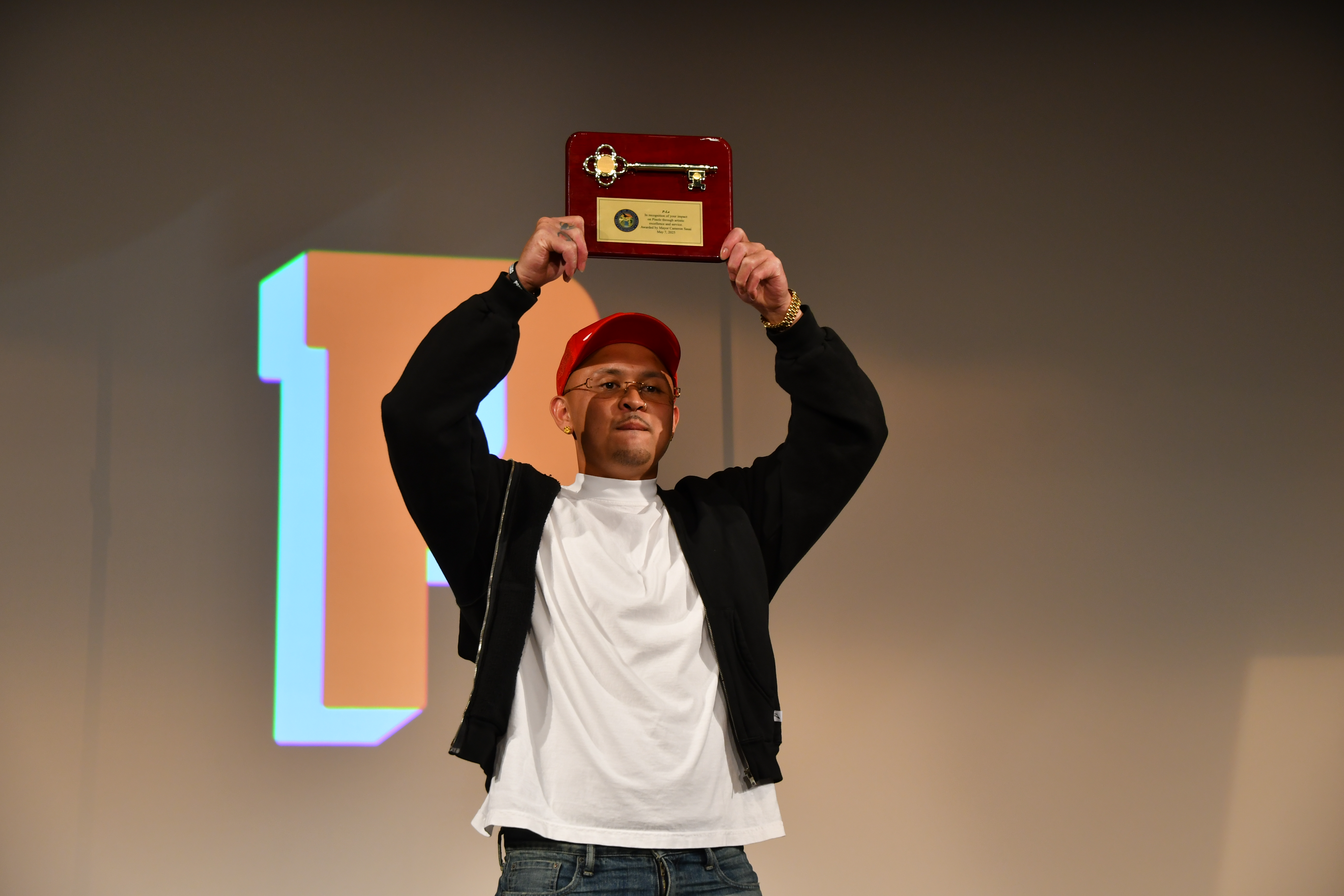 P-Lo holding up the key