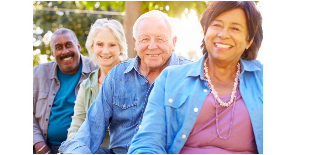 four smiling seniors outside