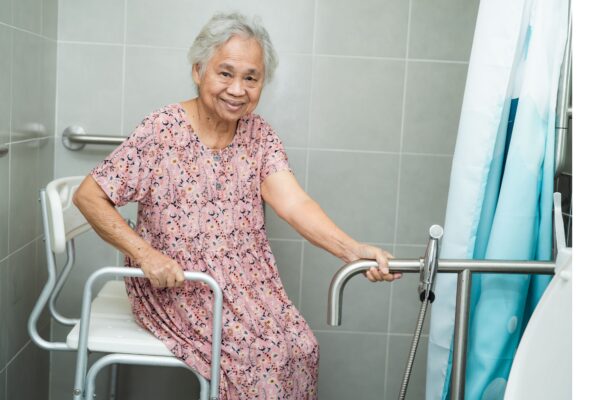 Senior woman in walk in shower with grab bars