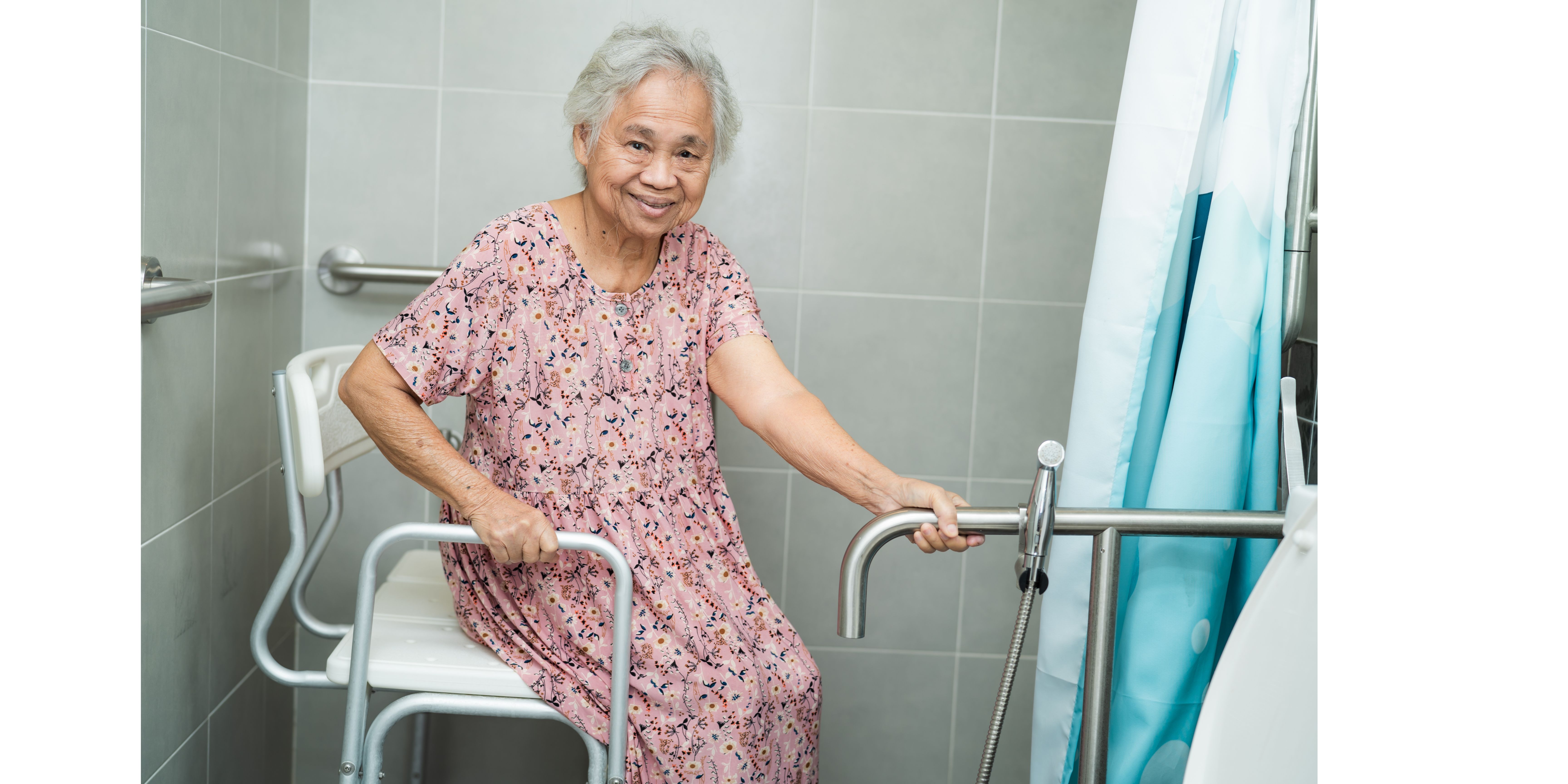 Senior woman in walk in shower with grab bars