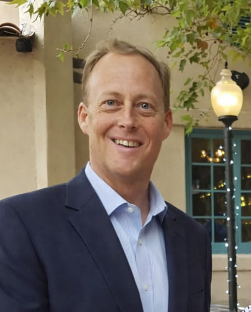man with short blonde hair in suit
