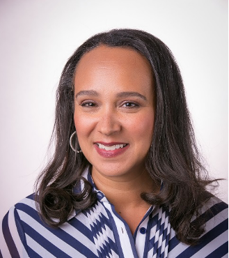 Naomi Kelly portrait - woman smiling with brown hair wearing a striped shirt