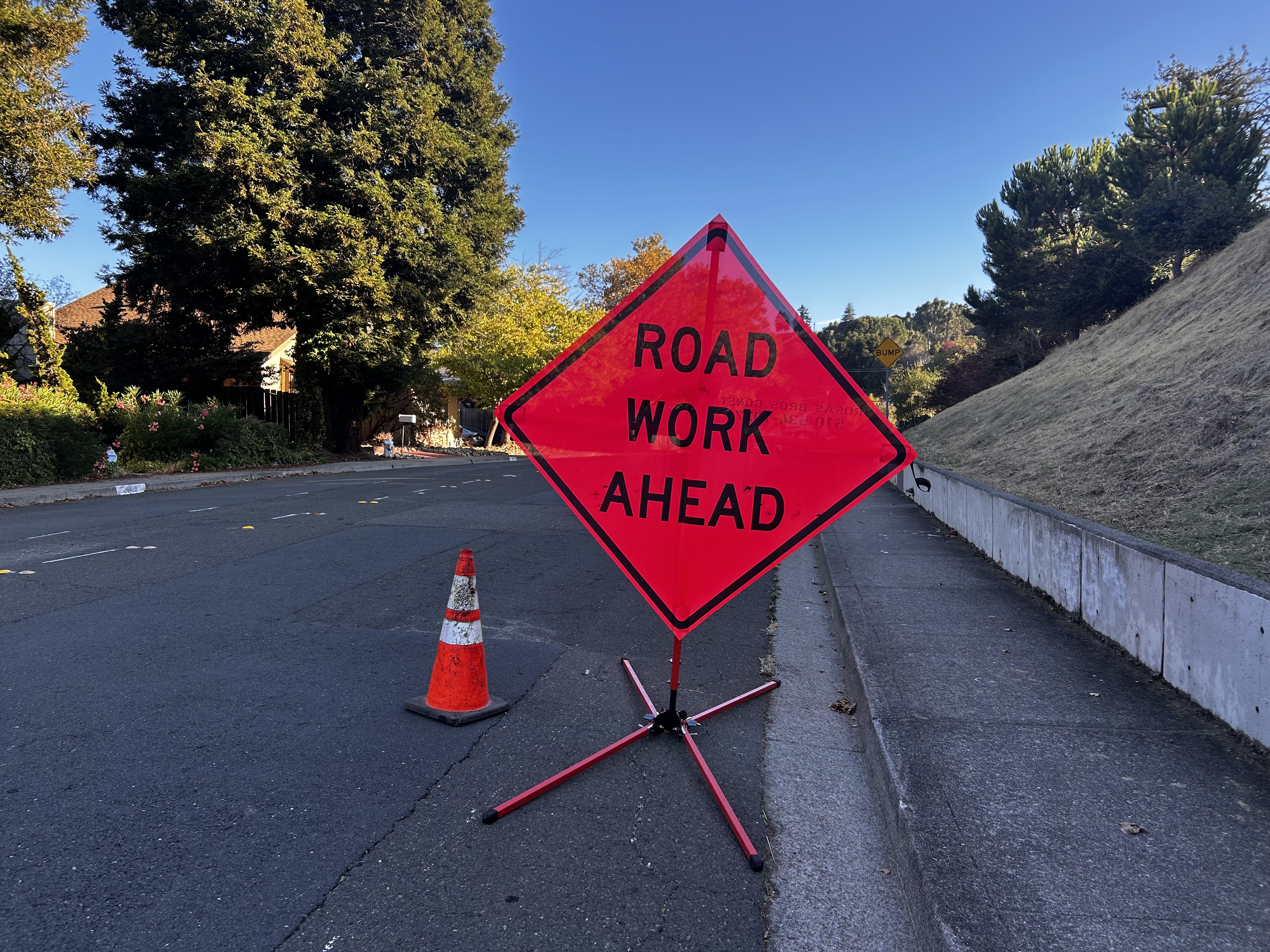 Road Work Ahead orange sign on street